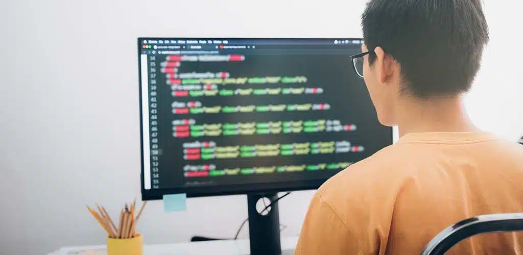 Man programming on computer